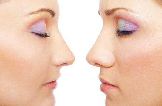 Close-up of two beautiful female faces, isolated on white, eyes closed