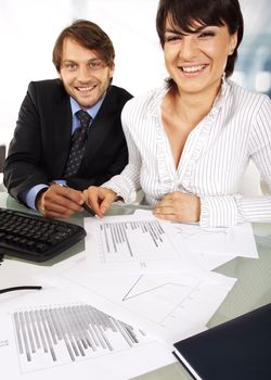 business couple is smiling at camera while making an analyses