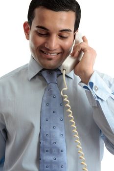 A smiling businessman on a telephone call. White background.