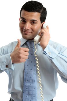 A businessman on a telephone call and with thumbs up success, approval, deal, etc.  White background.