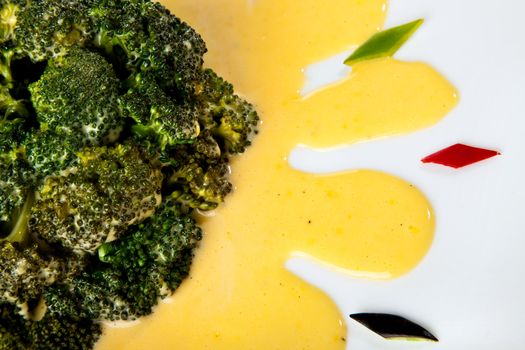 Close-up of delicious brocolli with sauce Hollandaise dish decorated