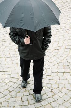 man with umbrella, special toned focus on nearest part