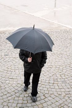 man with umbrella, special toned focus on nearest part