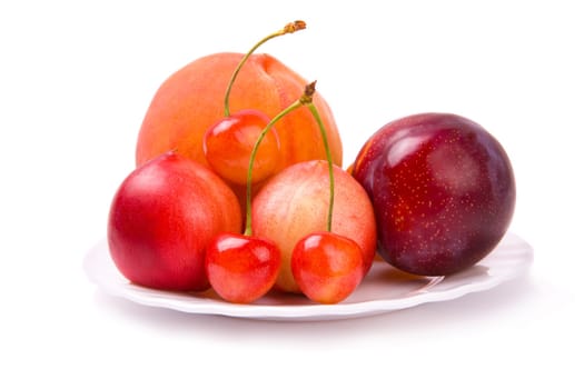 plate with fresh fruits isolated on white background