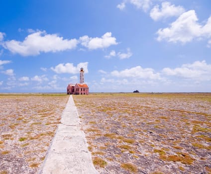 ancient lighthouse ruin on little curacao against blue cloudy sky 