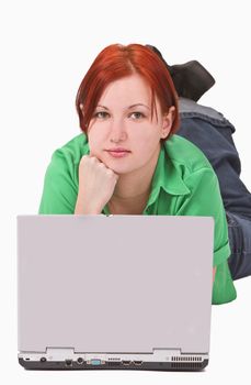 Portrait of a redheaded teenage girl lying down in front of a laptop.Shot with Canon 70-200mm f/2.8L IS USM