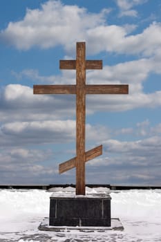 Orthodox cross on a background of the sky with clouds in the winter