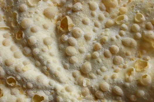 Close up of a Swiss 'Merveille', a sort of sweet pastry pancake eaten to celebrate the New Year. Suitable as a background image.