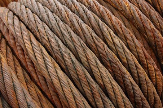 Close up detail of a coil of rusty iron rope. Suitable for background.