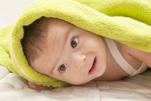 beautiful baby with a towel over your head
