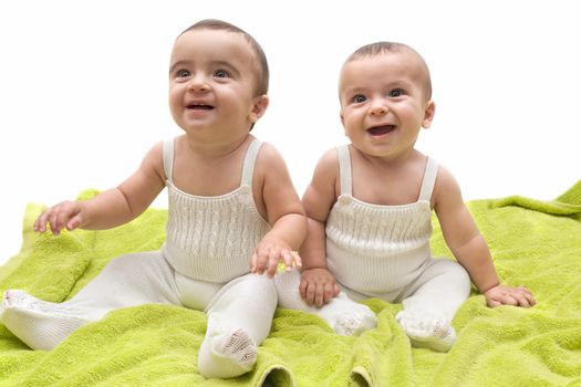 beautiful babies with the green towel on white background
