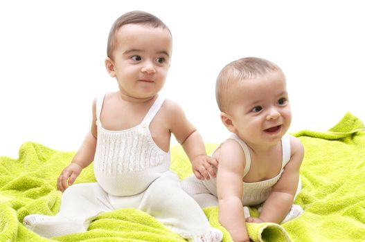 beautiful babies with the green towel on white background
