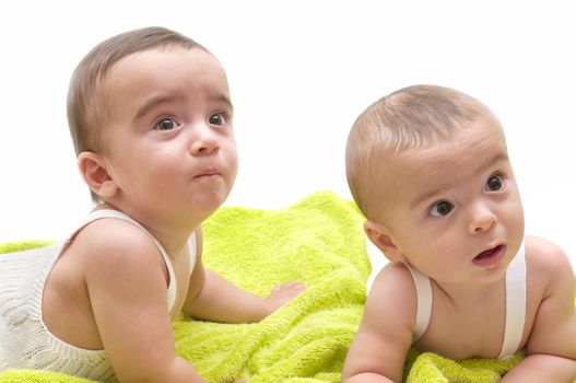 beautiful babies with the green towel on white background
