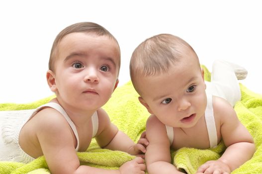 beautiful babies with the green towel on white background
