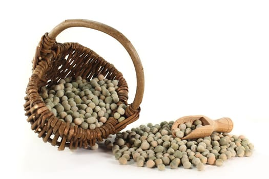 dried green peas in a basket on a white background