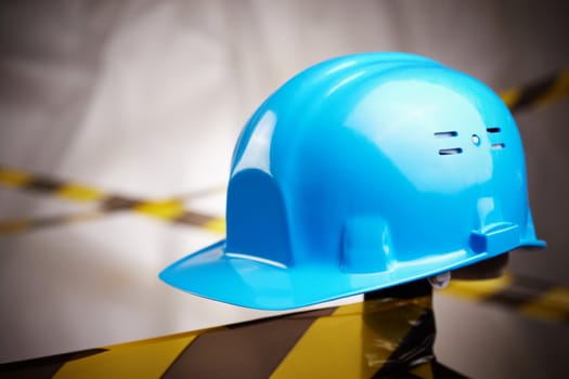 blue helmet and protective tape on site, selective focus on center