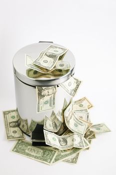 finance concept with money and metal tub on light grey background, focus on nearest part