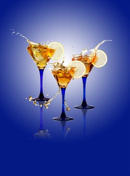 Three wineglasses with splashing beverage and lemon on gradient blue background. Isolated with clipping path