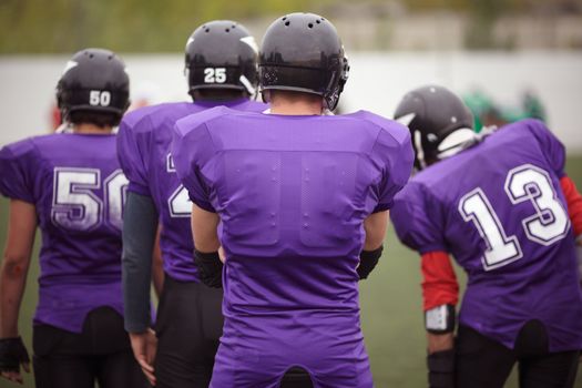 sport team concept, selective focus on black helmet of nearest man