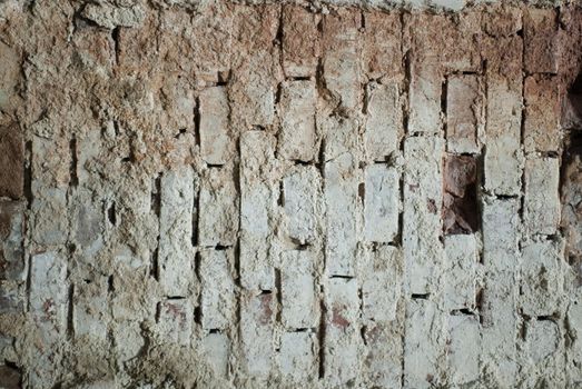 Old brick wall with pale gray bricks