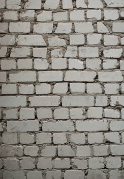 Old brick wall with pale gray bricks