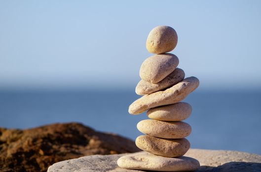 Pile of pebbles in the balance on the seacoast