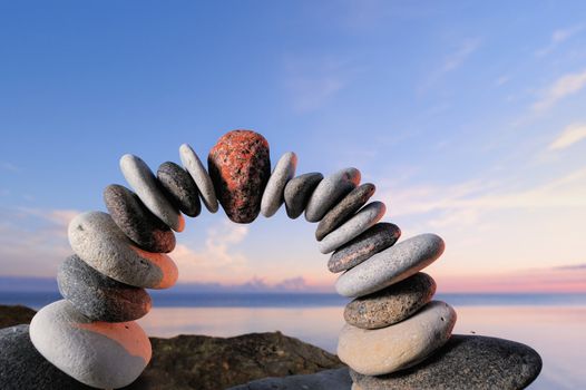 Red stone in the center arch of pebbles