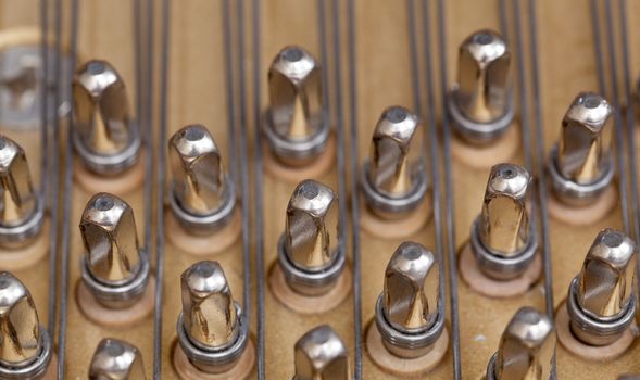 Close up image of interior of grand piano showing strings and structure
