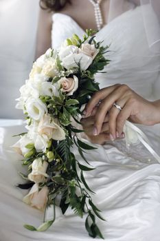 The bride holds a wedding bouquet