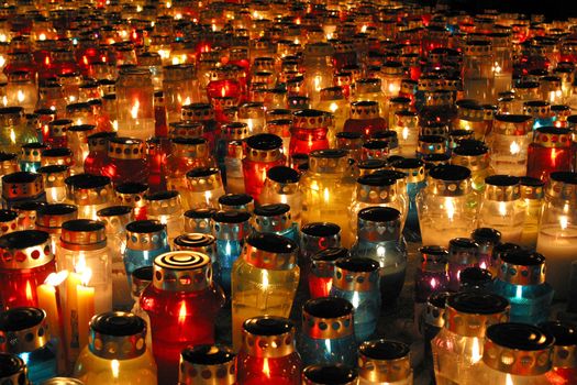 Memorial candles shining at the cemetery on the All Saints Day