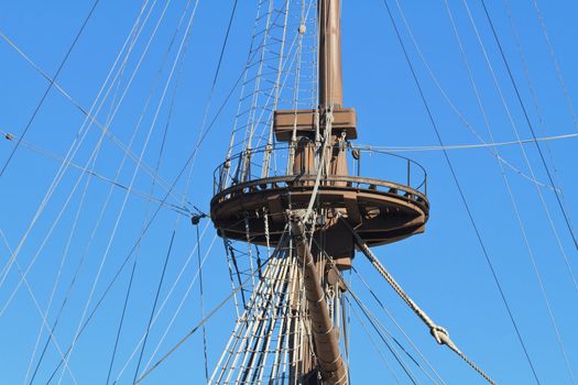 Detail of an ancient ship mast with bright blue sky