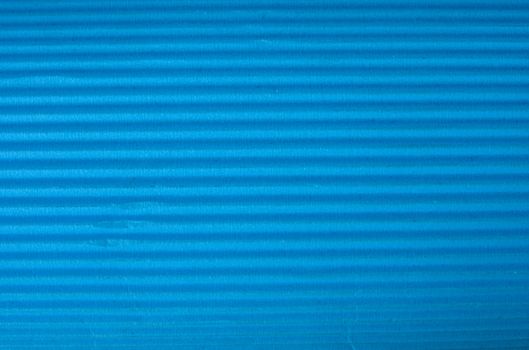 Vintage cyan corrugated cardboard macro close up. Useful as background for design works.