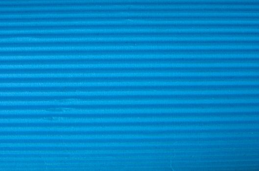 Vintage cyan corrugated cardboard macro close up. Useful as background for design works.