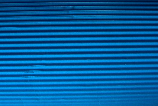 Vintage blue corrugated cardboard macro close up. Useful as background for design works.