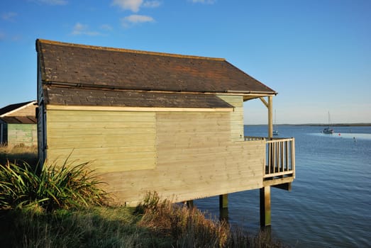 wooden house on side of river