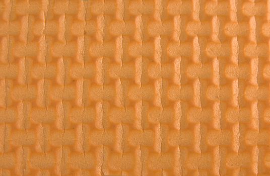 Orange woven rubber texture macro shot. Useful as background for design.