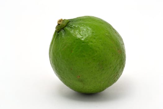 The single fresh green lime over white background