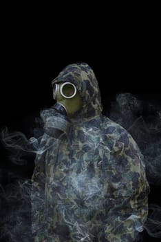 the man in anti-gas mask in vapours of gas