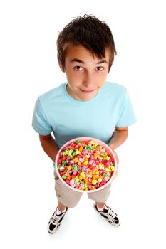 A boy holding a large bowl of coloured popcorn.  White background.
