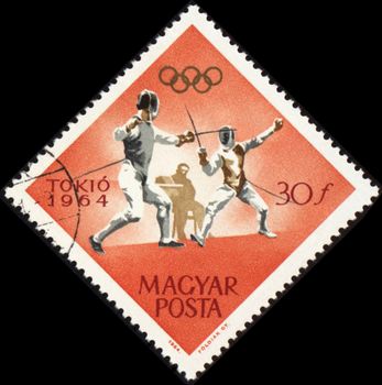 HUNGARY - CIRCA 1964: A post stamp printed in Hungary shows fencing, devoted to Olympic games in Tokio, series, circa 1964