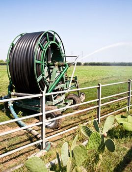 Irrigation operations in Italian country during a sunny day