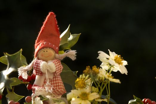 background christmas elf among winter flowers on black 