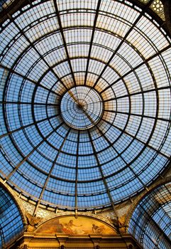 The Galleria Vittorio Emanuele II is a covered double arcade formed of two glass-vaulted arcades at right angles intersecting in an octagon, prominently sited on the northern side of the Piazza del Duomo in Milan.