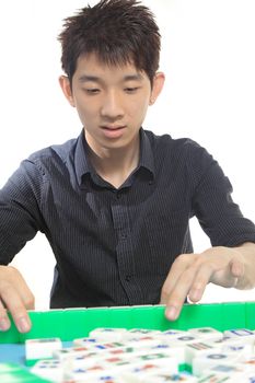 Chinese man play Mahjong, traditional China gamble. 