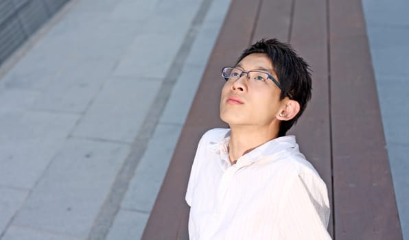 Young caucasian businessman sitting on bench