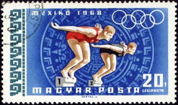 HUNGARY - CIRCA 1968: A post stamp printed in Hungary shows two jumping swimmers, devoted to Olympic games in Mexico, series, circa 1968