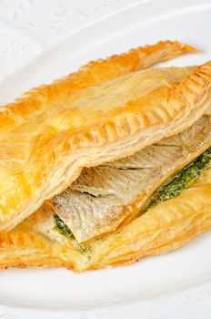 tasty dish of trout fish baked with greens at dough