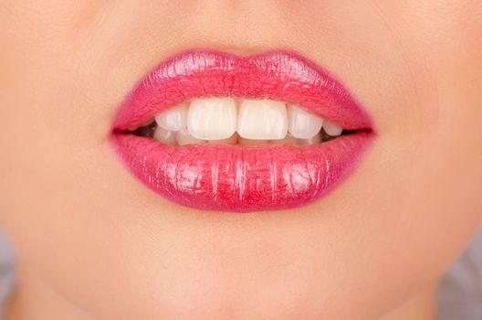 Close up of a young woman's glossy lips