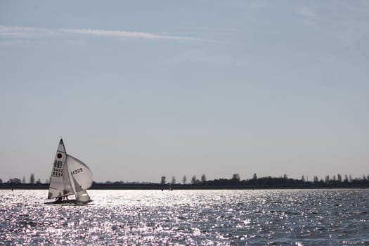 Sailing Boat on a lake under a blue sky