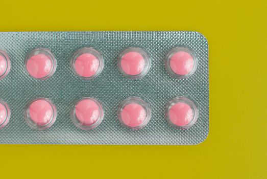 Macro view of medical pills on green background.